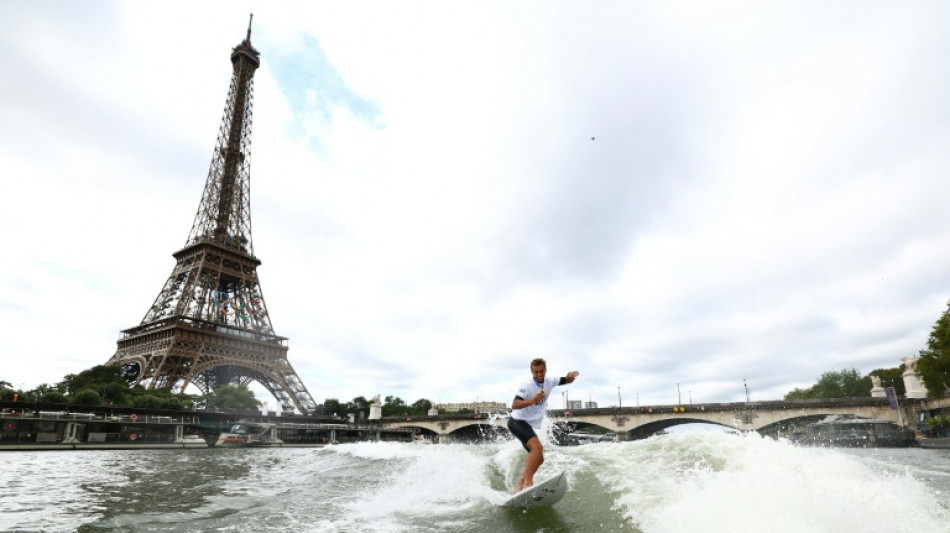 Tahitian surfing champion takes victory lap along the Seine