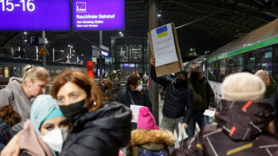 Tired and emotional, Ukrainians arrive by train in Berlin