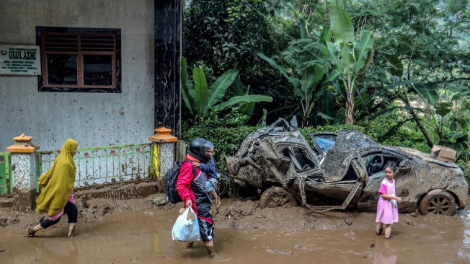 Indonesia digs out as flooding, landslide death toll hits 20