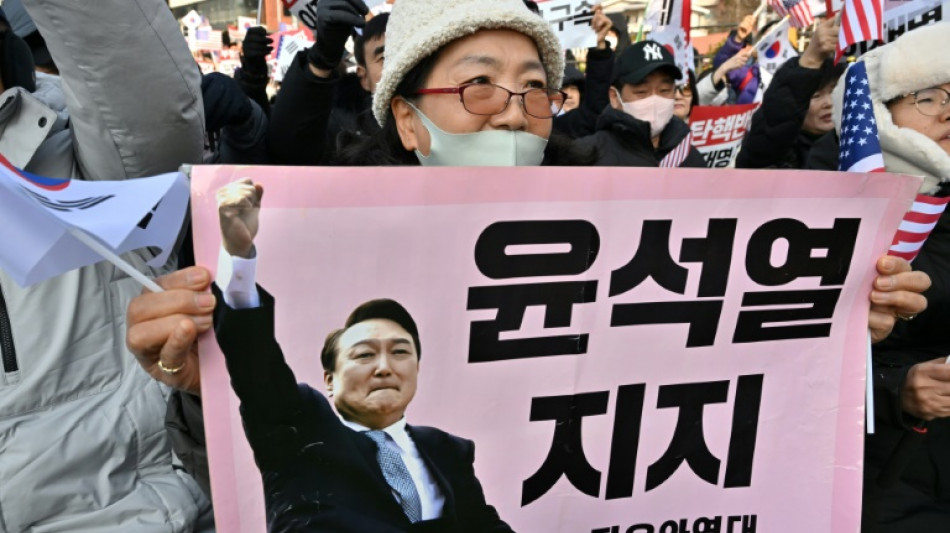 South Korea's impeached president resists arrest over martial law bid