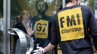 Climate activists block IMF Paris office doors
