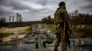 Ukrainian soldiers keep watch at recaptured border