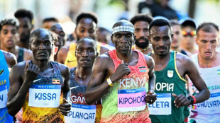 Marathon great Kipchoge hangs up his shoes... literally